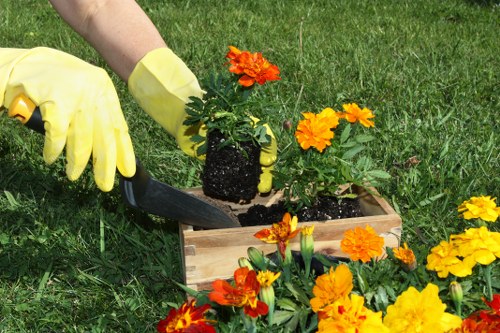Workers using protective gear during landscaping tasks